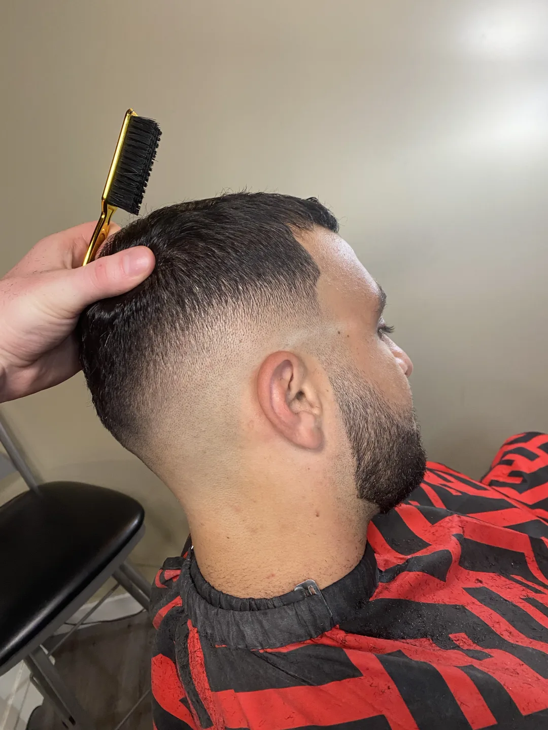 Mid skin fade blended to skin, razor clean — cut at Studio K barbershop in Guelph